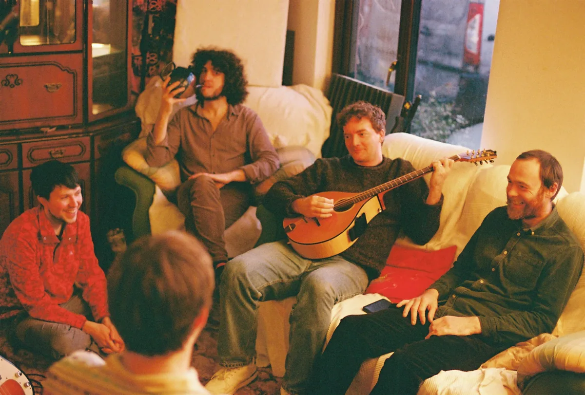 The musicians who played on Paul Spring's album Barnstorm gathered on a sofa during the sessions in County Galway, one playing a bouzouki