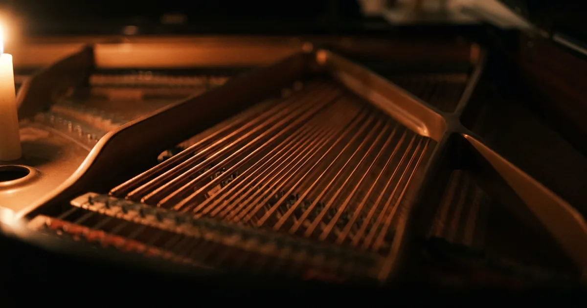 The copper-wound bass strings inside a grand piano, the low register where a descending lament bass line does its work